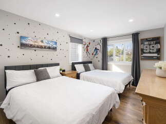 This charming bedroom features two comfortable beds, perfect for families or guests.