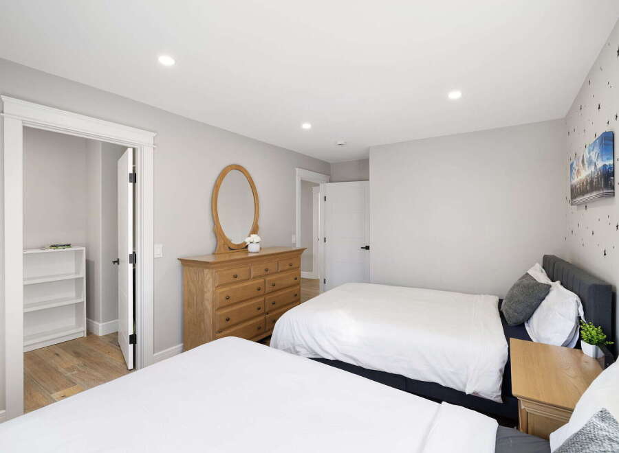 This inviting bedroom features two comfortable beds, perfect for accommodating family or guests.