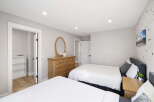 This inviting bedroom features two comfortable beds, perfect for accommodating family or guests.