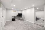 Discover this beautifully finished basement, offering a versatile space for work and fitness.
