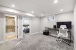 Discover comfortable living in this modern basement suite, featuring a spacious bedroom with a cozy grey duvet and a private ensuite bathroom with a walk-in shower.