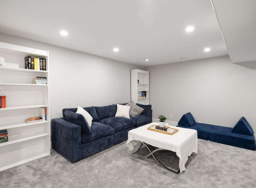 Discover this inviting living space featuring a plush navy blue sectional sofa, perfect for relaxation and entertaining.