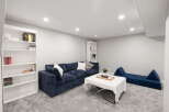 Discover this inviting living space featuring a plush navy blue sectional sofa, perfect for relaxation and entertaining.