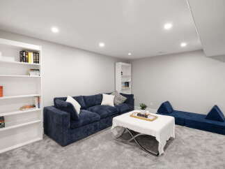Discover this inviting living space featuring a plush navy blue sectional sofa, perfect for relaxation and entertaining.