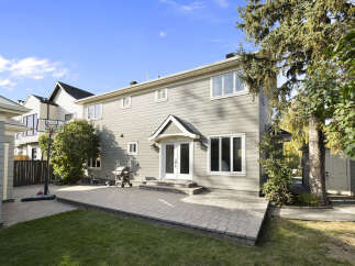 Enjoy outdoor living with this spacious backyard featuring a large paved patio perfect for entertaining.