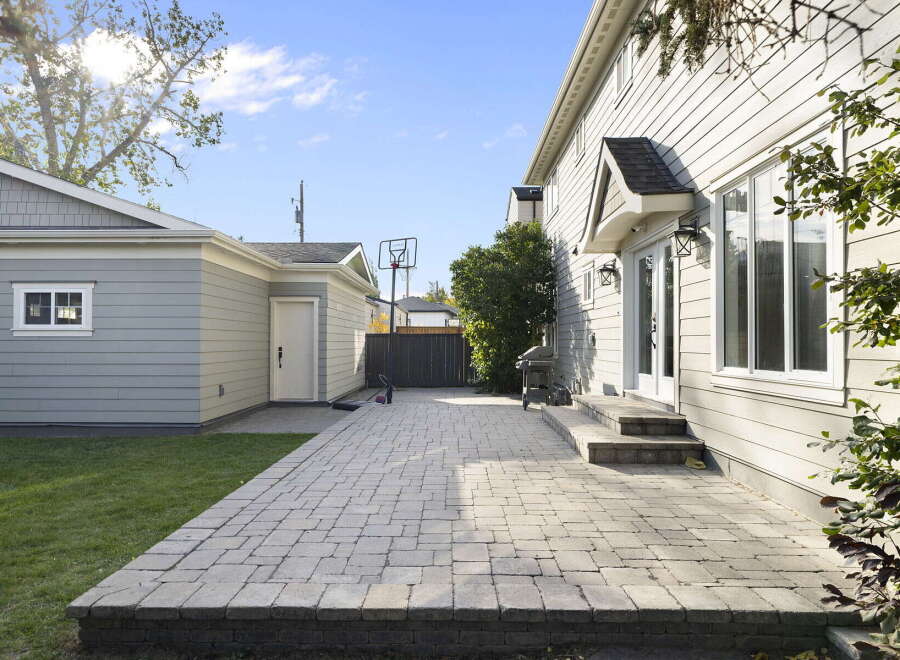 Enjoy outdoor living in this spacious backyard featuring a large paver patio perfect for entertaining.