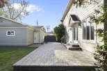 Enjoy outdoor living in this spacious backyard featuring a large paver patio perfect for entertaining.