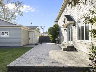 Enjoy outdoor living in this spacious backyard featuring a large paver patio perfect for entertaining.