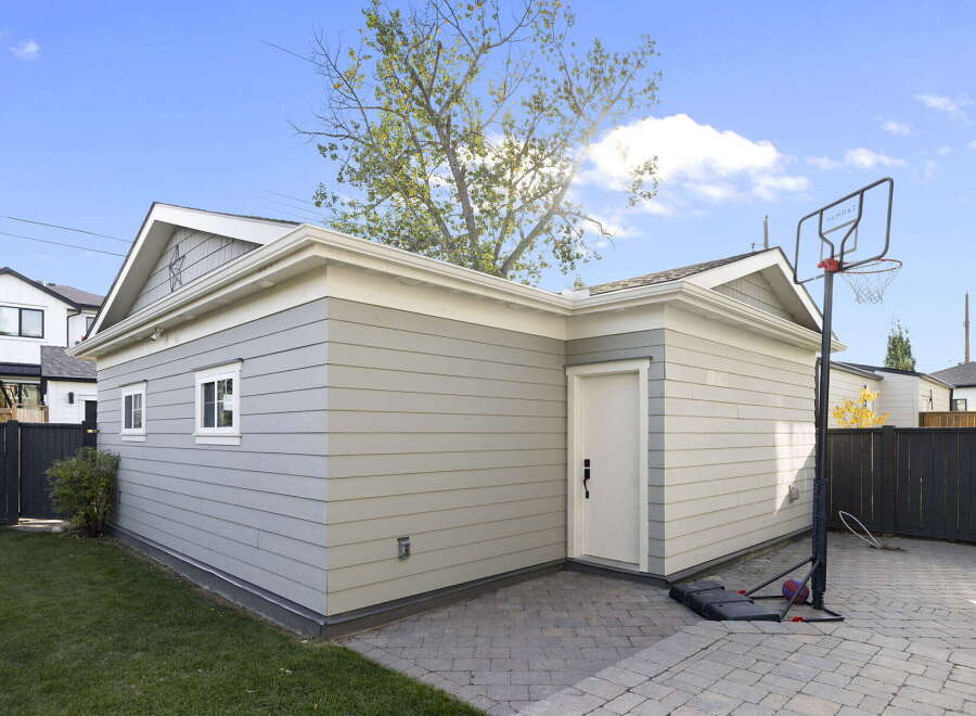 Discover this charming property featuring a detached garage with a classic gable roof and attractive siding.