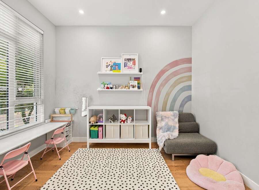 This charming room features a bright and airy atmosphere, perfect for a child's playroom or creative space.