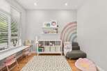 This charming room features a bright and airy atmosphere, perfect for a child's playroom or creative space.