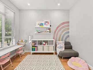 This charming room features a bright and airy atmosphere, perfect for a child's playroom or creative space.