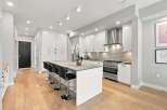 Experience modern living in this stunning kitchen featuring sleek white cabinetry and a spacious island perfect for entertaining.