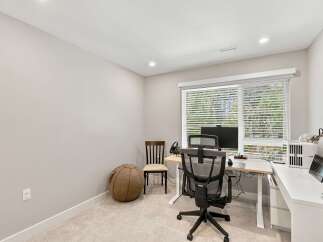 This home office features a spacious desk with a computer setup, perfect for remote work or study.