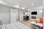 Discover modern living in this stylish studio apartment, featuring a cozy fireplace and a sleek entertainment area.