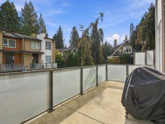 Enjoy outdoor living on this spacious balcony, complete with a modern glass railing offering unobstructed views.