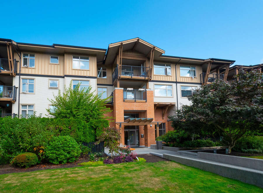 Discover modern living in this stunning apartment building, featuring spacious balconies and elegant brick accents.