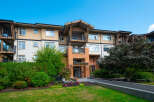 Discover modern living in this stunning apartment building, featuring spacious balconies and elegant brick accents.