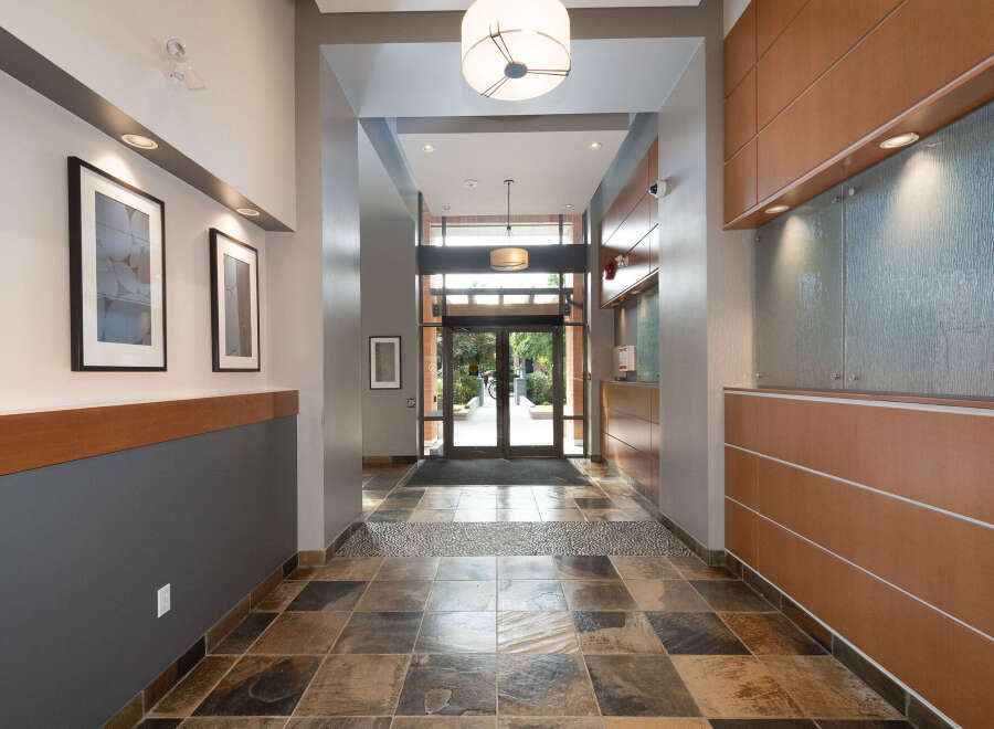 Step into this inviting entryway featuring a striking slate tile floor and elegant framed artwork adorning the walls.