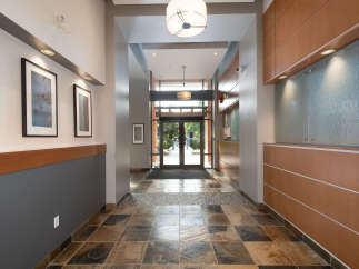 Step into this inviting entryway featuring a striking slate tile floor and elegant framed artwork adorning the walls.