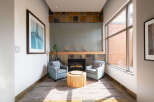 Experience modern comfort in this inviting living space, featuring a cozy fireplace as the focal point.
