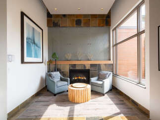 Experience modern comfort in this inviting living space, featuring a cozy fireplace as the focal point.