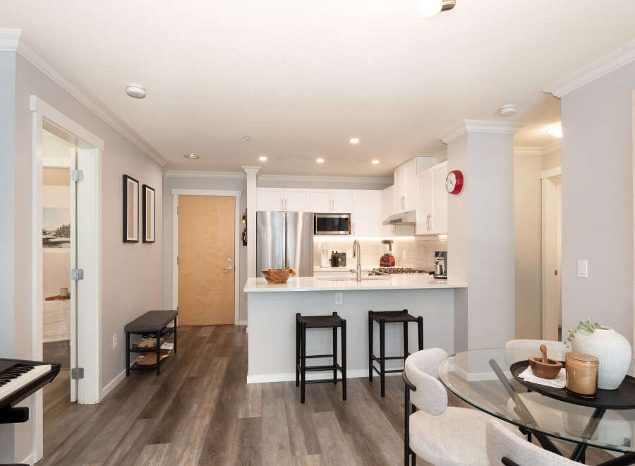 Discover modern living in this beautifully appointed condo, featuring a sleek, open-concept kitchen with stainless steel appliances and a spacious island perfect for entertaining.