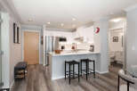 Discover modern living in this stylish condo featuring a sleek kitchen with stainless steel appliances and a convenient breakfast bar.