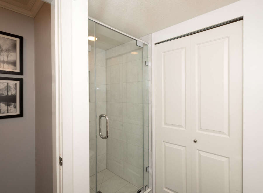 Step into this beautifully appointed bathroom, featuring a sleek glass-enclosed shower with modern tile work.