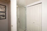 Step into this beautifully appointed bathroom, featuring a sleek glass-enclosed shower with modern tile work.