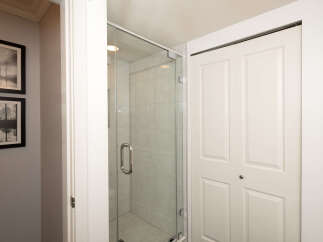 Step into this beautifully appointed bathroom, featuring a sleek glass-enclosed shower with modern tile work.