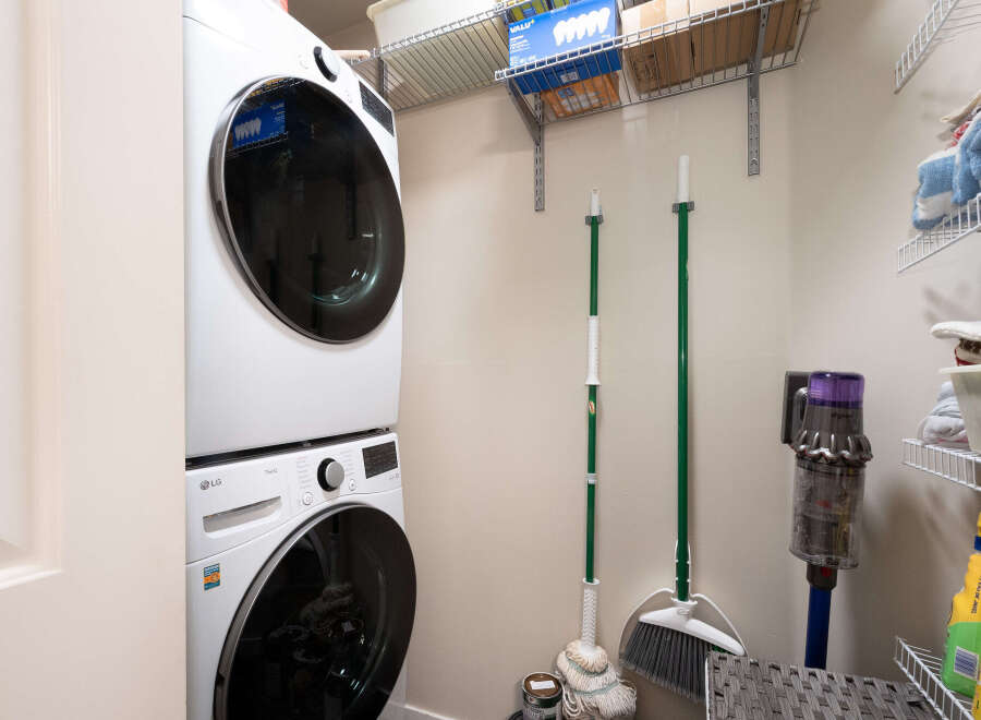 This laundry room features a stacked LG washer and dryer set, perfect for maximizing space in your home.