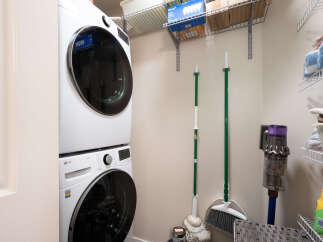 This laundry room features a stacked LG washer and dryer set, perfect for maximizing space in your home.