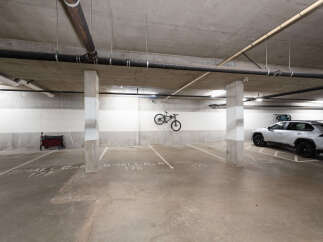 Discover convenient parking solutions in this well-maintained garage, featuring designated spots for small cars and a handicap-accessible space.