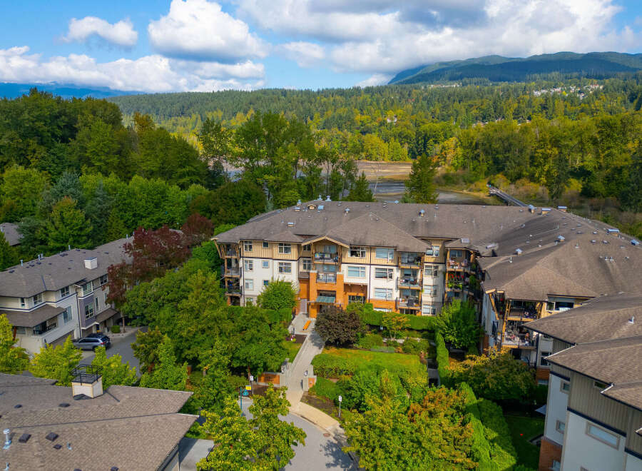 Discover modern living in this stunning condo complex, nestled amidst lush greenery and offering picturesque mountain views.