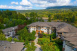 Discover modern living in this stunning condo complex, nestled amidst lush greenery and offering picturesque mountain views.