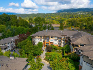 Discover modern living in this stunning condo complex, nestled amidst lush greenery and offering picturesque mountain views.