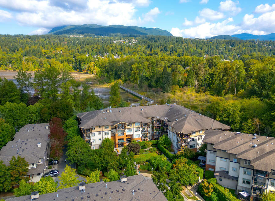 Discover modern living in this stunning condo complex, nestled amidst lush greenery and offering breathtaking mountain views.