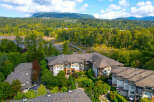 Discover modern living in this stunning condo complex, nestled amidst lush greenery and offering breathtaking mountain views.