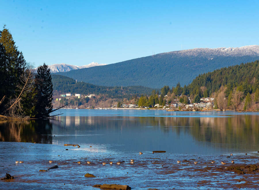 Discover serene waterfront living with this stunning property offering breathtaking views of the lake and snow-capped mountains.