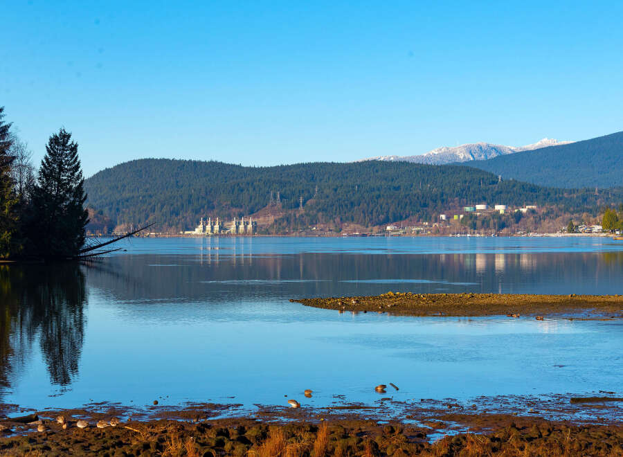 Experience serene waterfront living with this stunning property offering breathtaking views of the tranquil bay and majestic mountains.