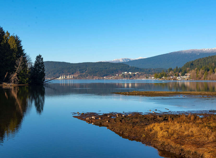 Experience serene waterfront living with this stunning property offering breathtaking views of the tranquil bay and majestic mountains.