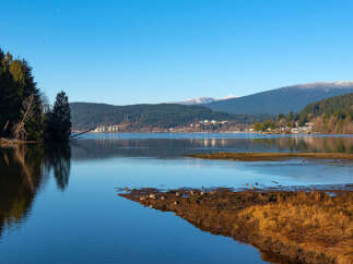 Experience serene waterfront living with this stunning property offering breathtaking views of the tranquil bay and majestic mountains.