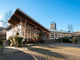 Discover this stunning property featuring a unique architectural design with a prominent pitched roof supported by exposed wooden beams.