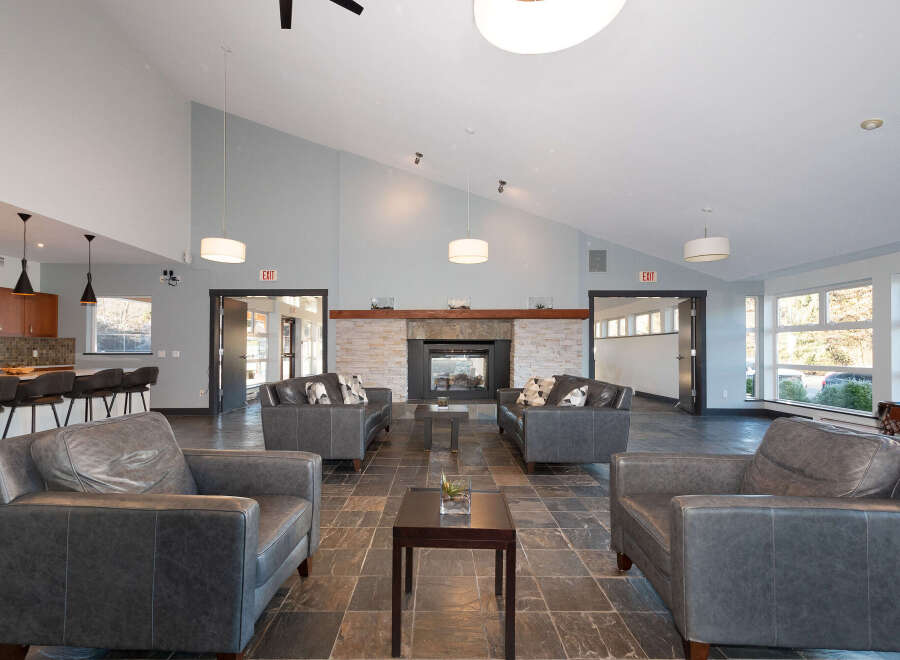 Experience modern comfort in this spacious living area, featuring a cozy fireplace and ample seating.
