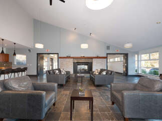 Experience modern comfort in this spacious living area, featuring a cozy fireplace and ample seating.