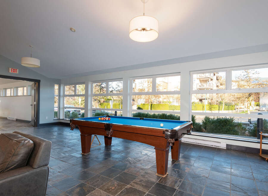 Enjoy leisure time in this spacious game room featuring a professional-grade pool table and comfortable seating.