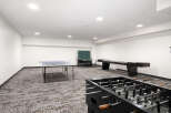Enjoy endless entertainment in this spacious game room, featuring a ping pong table, foosball table, and shuffleboard.