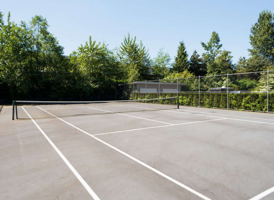 Enjoy outdoor recreation on this pristine tennis court, perfect for residents seeking an active lifestyle.