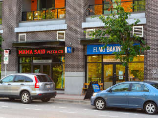 Discover vibrant commercial spaces in a prime urban location, featuring prominent storefronts for 'Mama Said Pizza Co.